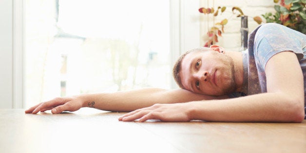 Young man resting on table