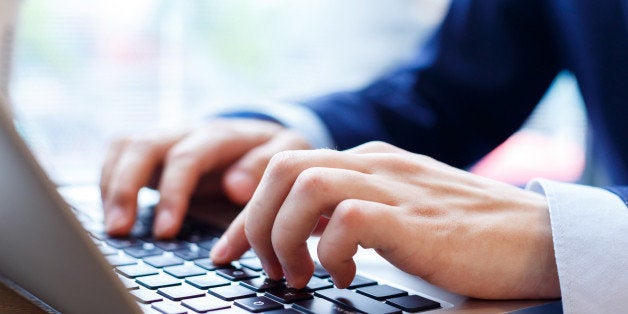 close up view of businessman typing on laptop indoors