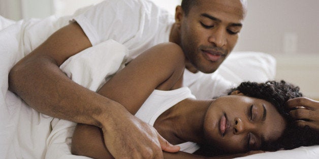 Couple embracing in bed