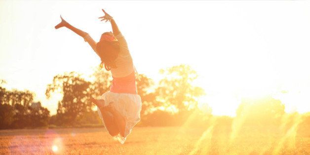 Girl jumping into the sunshine