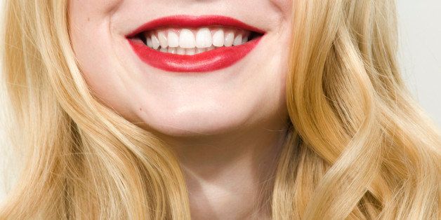 Young woman smiling, red lips, close up