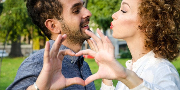 boyfriend and girlfriend make heart shape of the hands