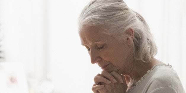 Senior Caucasian woman praying