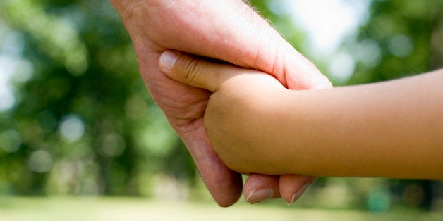 Grandfather and grandchild holding hands