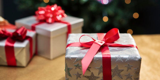 Presents in front of Christmas tree.