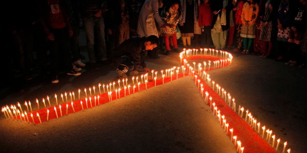 Nepalese women and children from ￃﾢￂﾀￂﾜMaiti Nepalￃﾢￂﾀￂﾝ, a rehabilitation center for victims of sex trafficking, light candles on the eve of World AIDS Day in Kathmandu, Nepal, Monday, Nov. 30, 2015. World AIDS Day is observed on December 1 every year to raise the awareness in the fight against HIV. (AP Photo/Niranjan Shrestha)