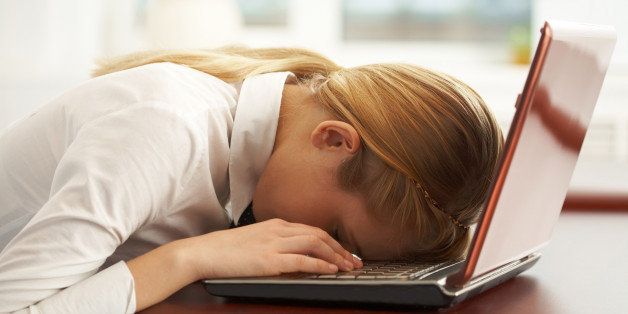 Image of very tired businesswoman or student with her face on keyboard of laptop Note to inspector: the image is pre-Sept 1 2009