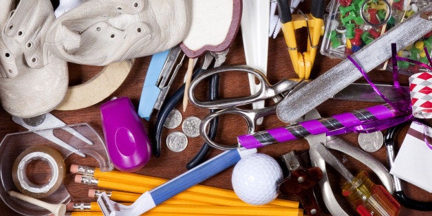 Junk Drawer with miscellaneous objects, Including, Baby Shoes Elastic Bands, Pencils, Compass, New Years Eve Party Blower, Fake Hand, Cellophane Tape, and More. Image shot with, Canon 5D Mark2 , 100 ISO, 24-115mm lens and studio strobes.