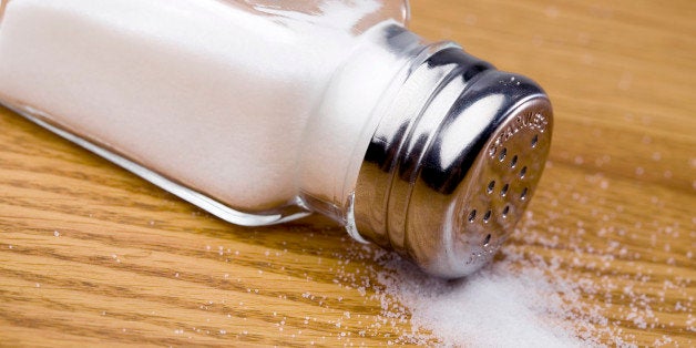 Overturned salt shaker spilling salt