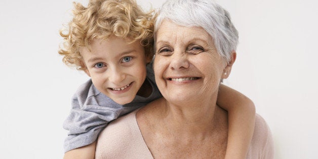 Portrait of a grandmother giving her grandson a piggyback ride