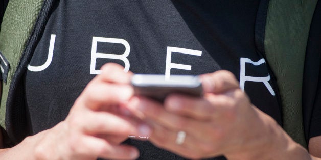 CANBERRA, AUSTRALIA - OCTOBER 30: Uber staff track the first regulated UberX ride in Australia on October 30, 2015 in Canberra, Australia. The Australian Capital Territory is the first jurisdiction in the world to legalise UberX, allowing people to access and offer ridesharing services without fear of fines or license suspensions. (Photo by Martin Ollman/Getty Images)