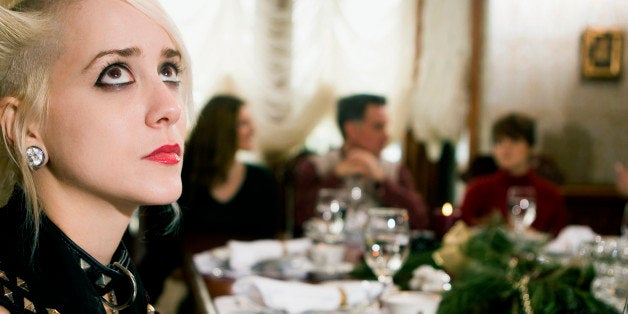 Young woman looking up at dining table