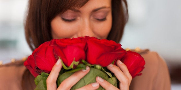 Woman smelling roses