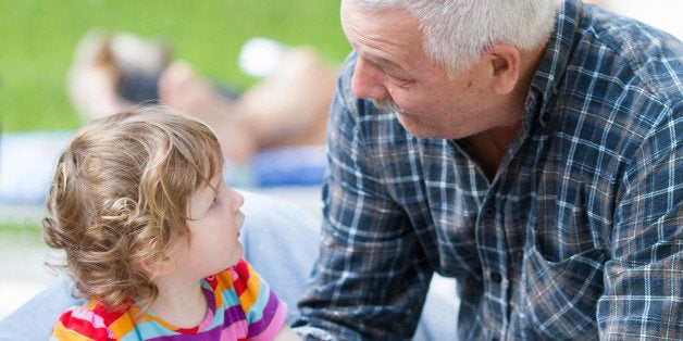 grandfather talking with his granddaughter