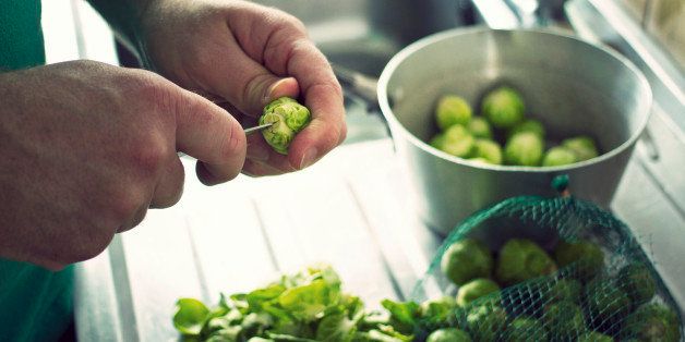 Brussels Sprouts being prepared at a kitchen sink in readiness for Christmas Dinner