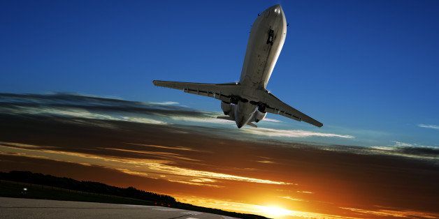 corporate jet airplane landing on runway at sunset (XL)