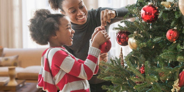 Mother and daughter decorating Christmas tree