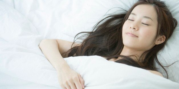 Young woman sleeping on bed, portrait