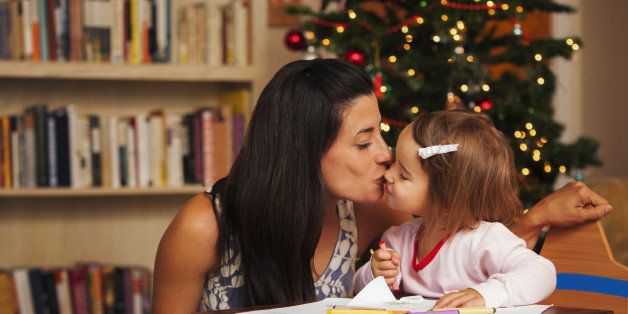 Mother and daughter writing letter to Santa Claus