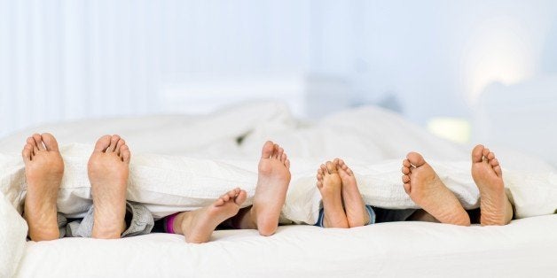 A family sleeping in the same bed