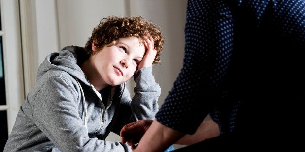 'Eleven year old boy talking to a parent,guardian or social worker.'