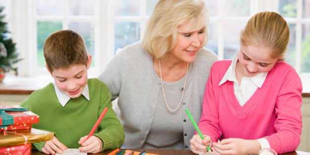 Grandmother and grandchildren making Christmas cards
