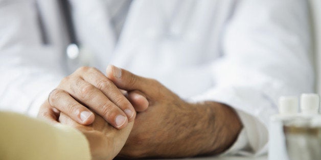 Doctor comforting patient during consultation