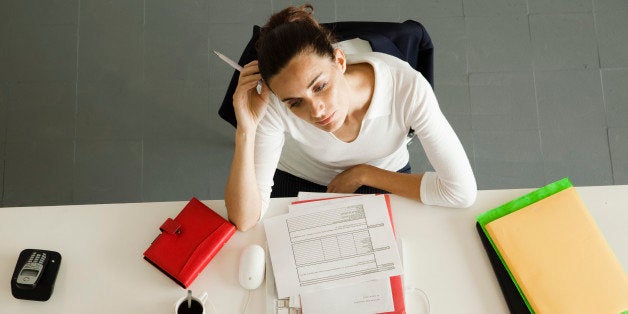 Businesswoman daydreaming at desk