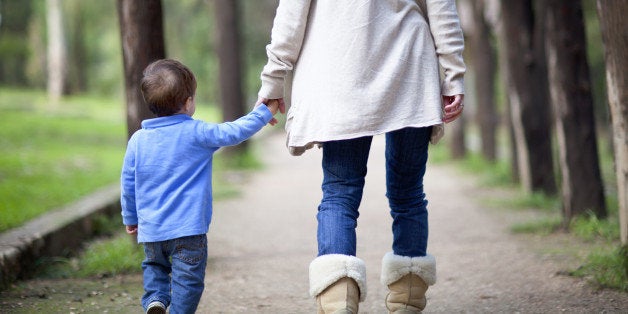 Woman with her kid walking in a park