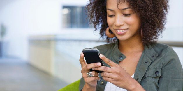 African American woman using mobile phone in university