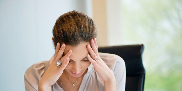 Close-up of a businesswoman suffering from a headache in an office