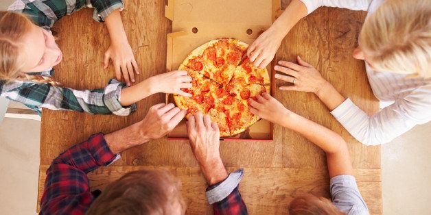 Family eating pizza together, overhead view