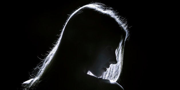 sad woman profile silhouette in dark