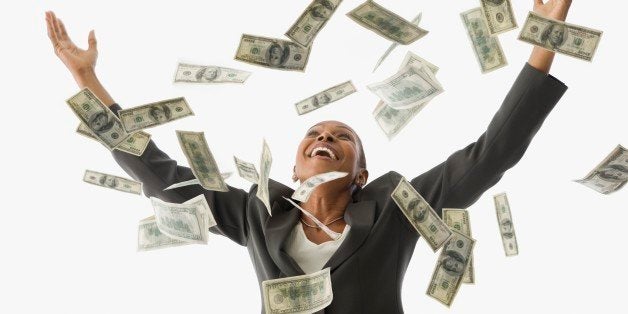 African American businesswoman throwing money in the air