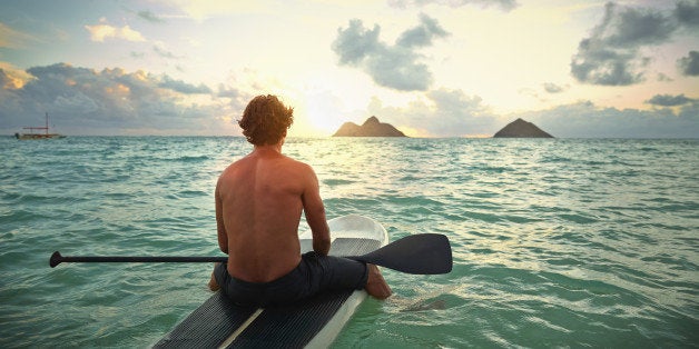 Caucasian man on paddle board in ocean