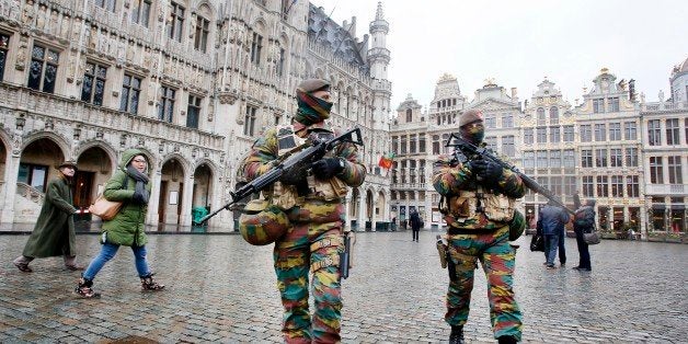 Belgium police officers patrol the Grand Place in central Brussels, Belgium, Tuesday, Nov. 24, 2015. The lockdown has closed the capitalￃﾢￂﾀￂﾙs subways and schools. Officials have recommended that popular shopping districts be shuttered and advised people to avoid public places since they could be targeted by terrorists. (AP Photo/Michael Probst)