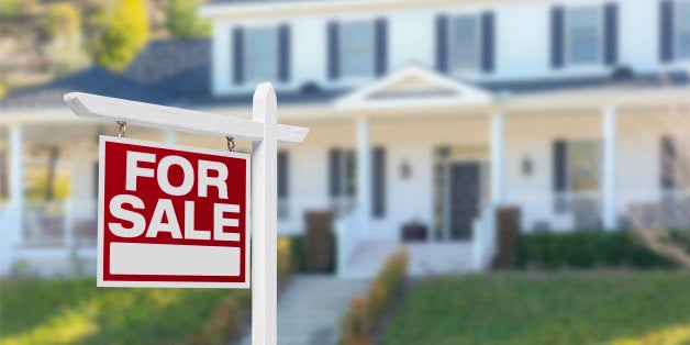 Home For Sale Real Estate Sign in Front of Beautiful New House.