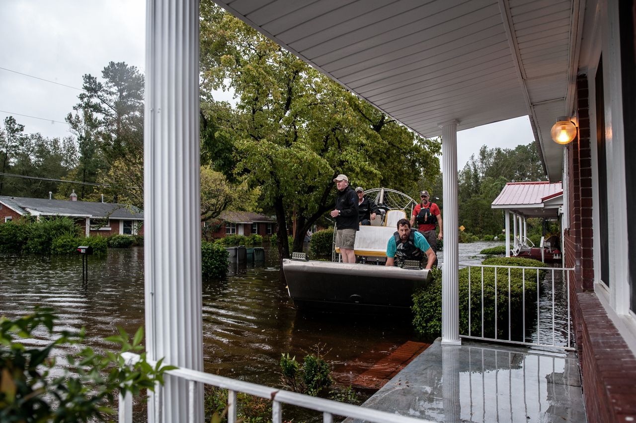 A boat crew with the Cajun Navy goes house to house to check for people in need of evacuation in Lumberton.