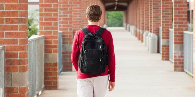 Caucasian teenage boy walking on school campus