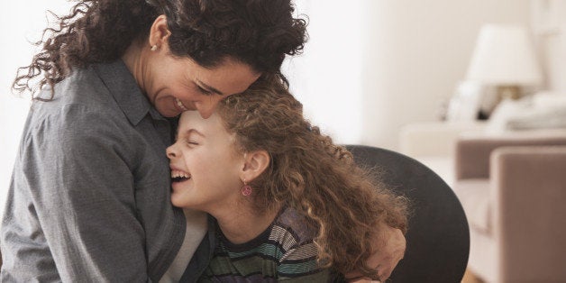 Hispanic mother and daughter hugging