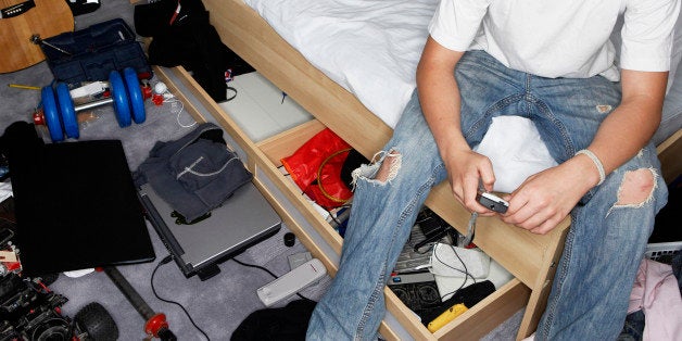 Teenage Boy in Messy Bedroom