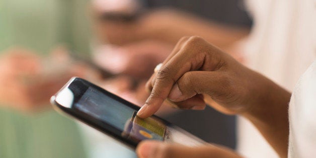 Close up of woman using cell phone touch screen