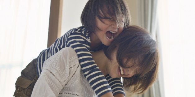 Mother giving daughter a piggyback ride,Girl of five years,Japan