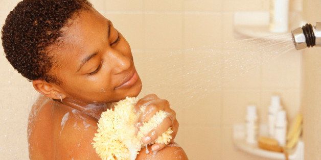 Woman washing using sponge in shower