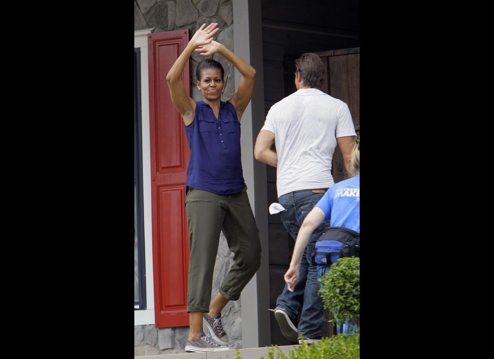 First lady Michelle Obama waves as she enters the Jubilee House during the taping of "Extreme Makeover: Home Edition" in Fayetteville, N.C.