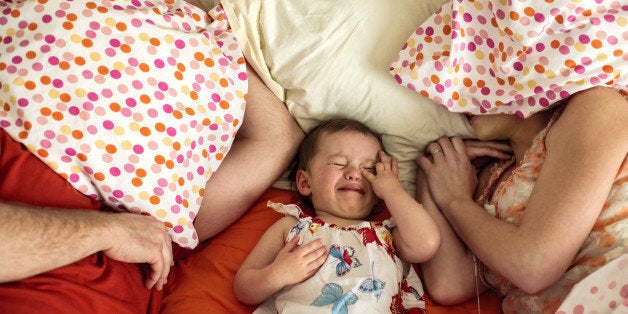 Crying toddler with parents