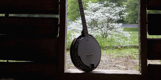 A banjo in the doorway of a cabin