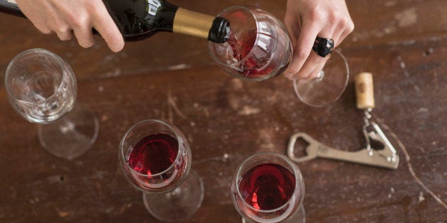 USA, New Jersey, Elevated view of woman pouring red wine