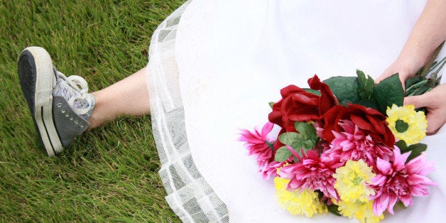 A bride wearing running shoes and a wedding gown