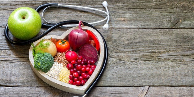 Healthy food in heart and cholesterol diet concept on vintage boards